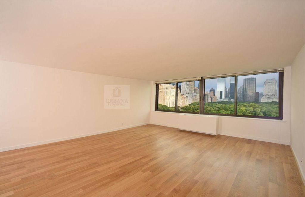 Open layout view with wood floors and large windows with Central Park Views