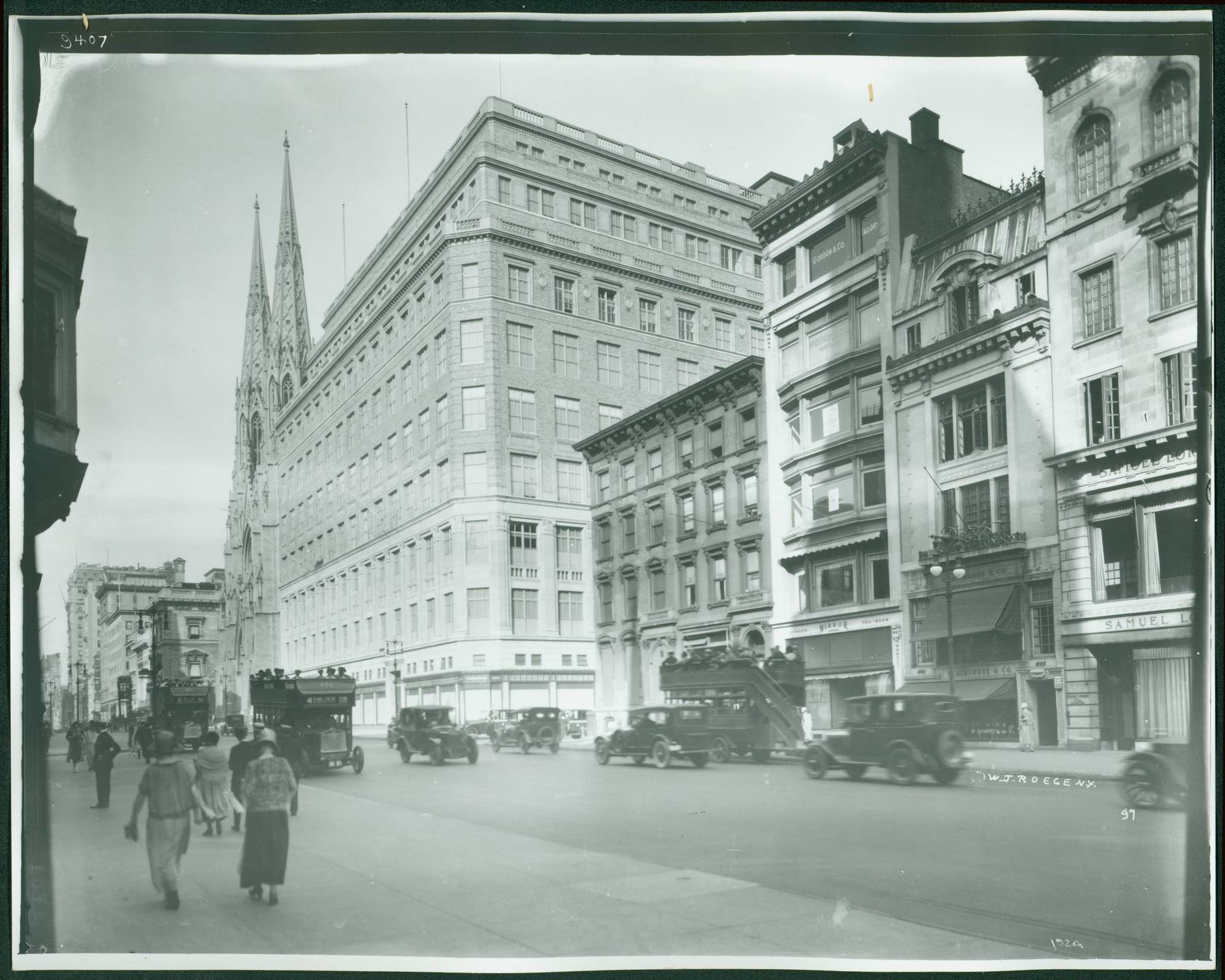 B&w photo of Saks fifth ave and St. Patrick's Cathedral with people and cars on the street