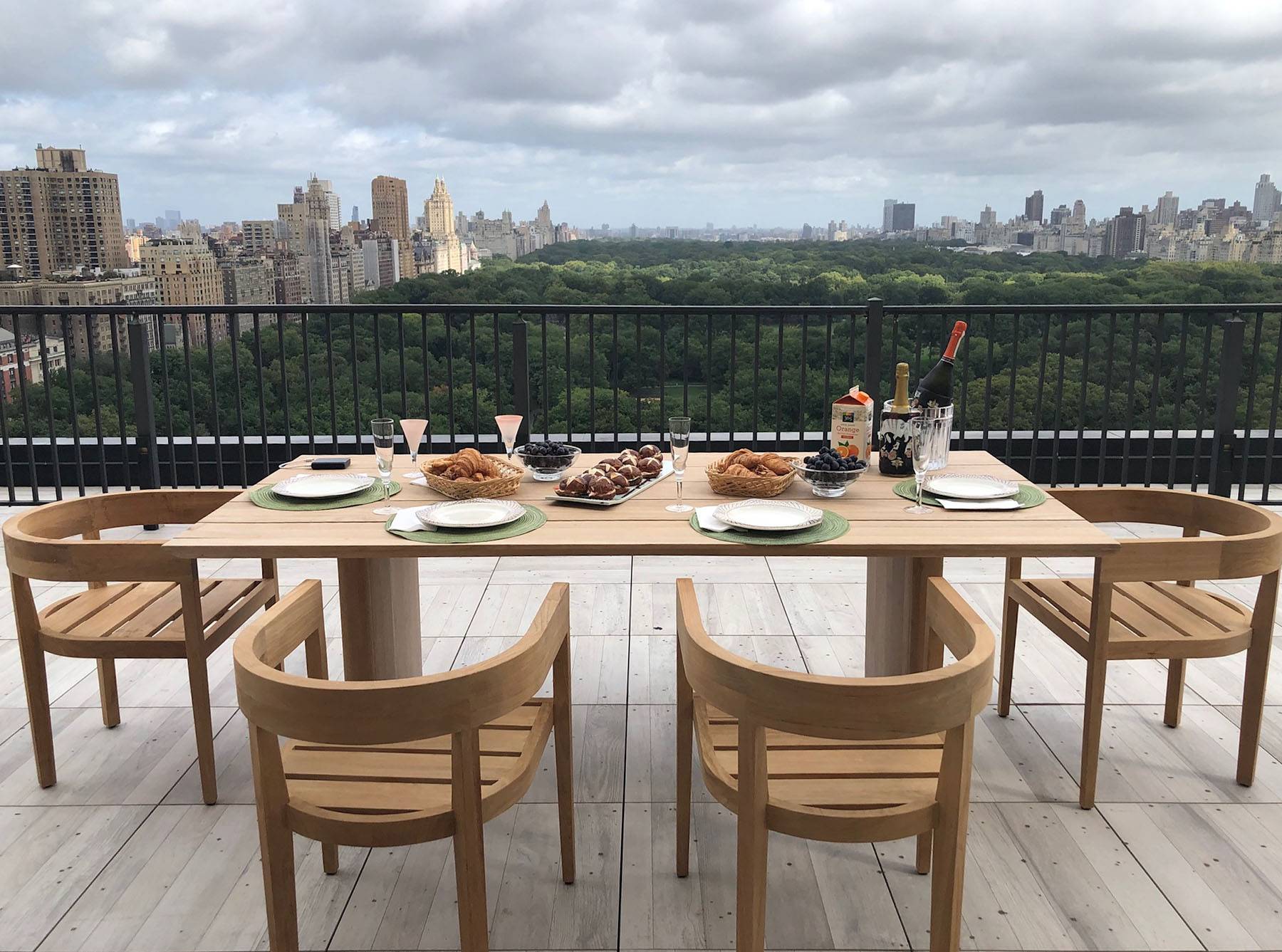 Roof Deck with dining seating and city view at 210 Central Park South