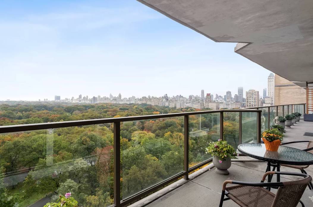 Balcony with seating and flowers and city views at 210 Central Park South