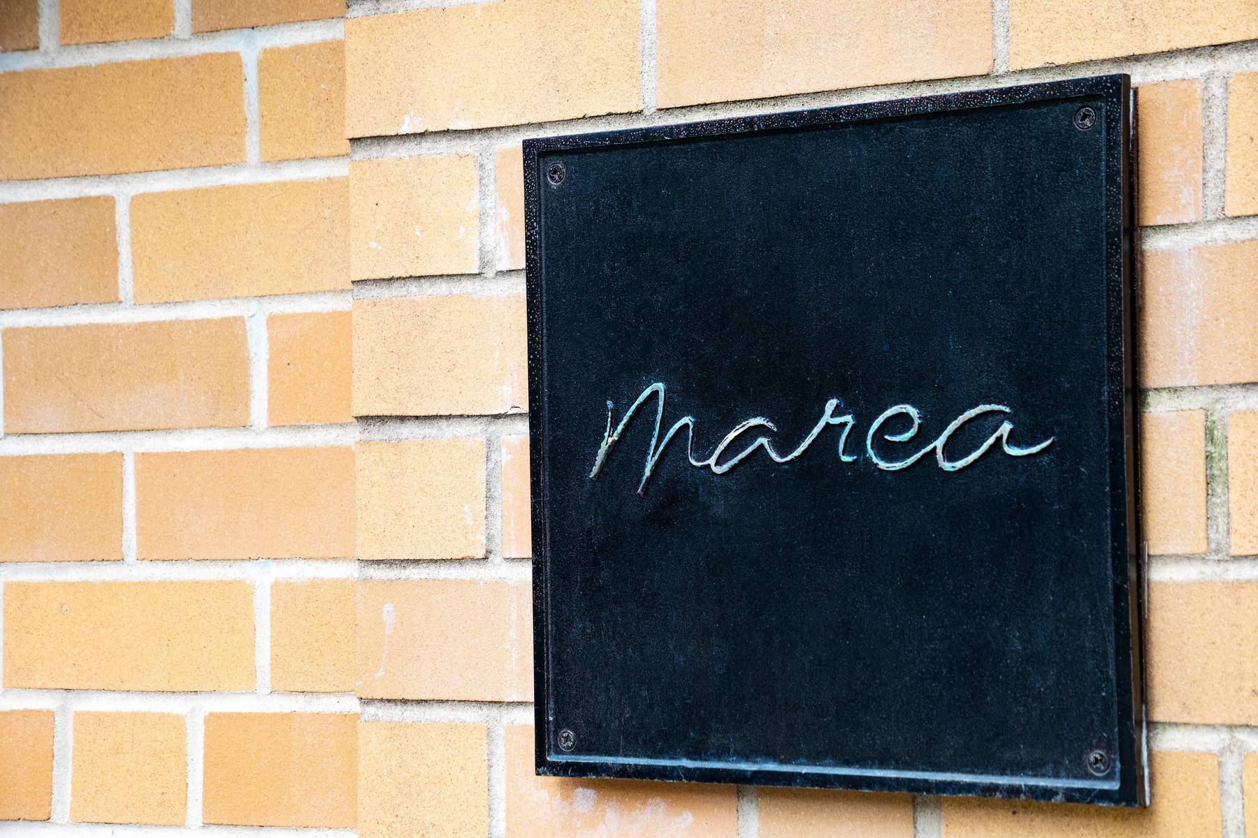 marea metal sign on brick building detail